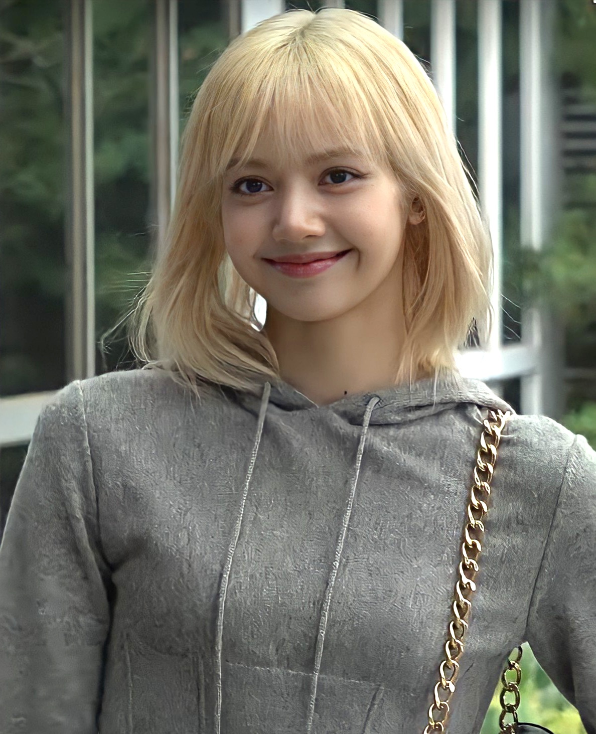 LISA of BLACKPINK smiling outdoors in a gray hooded top, June 2022