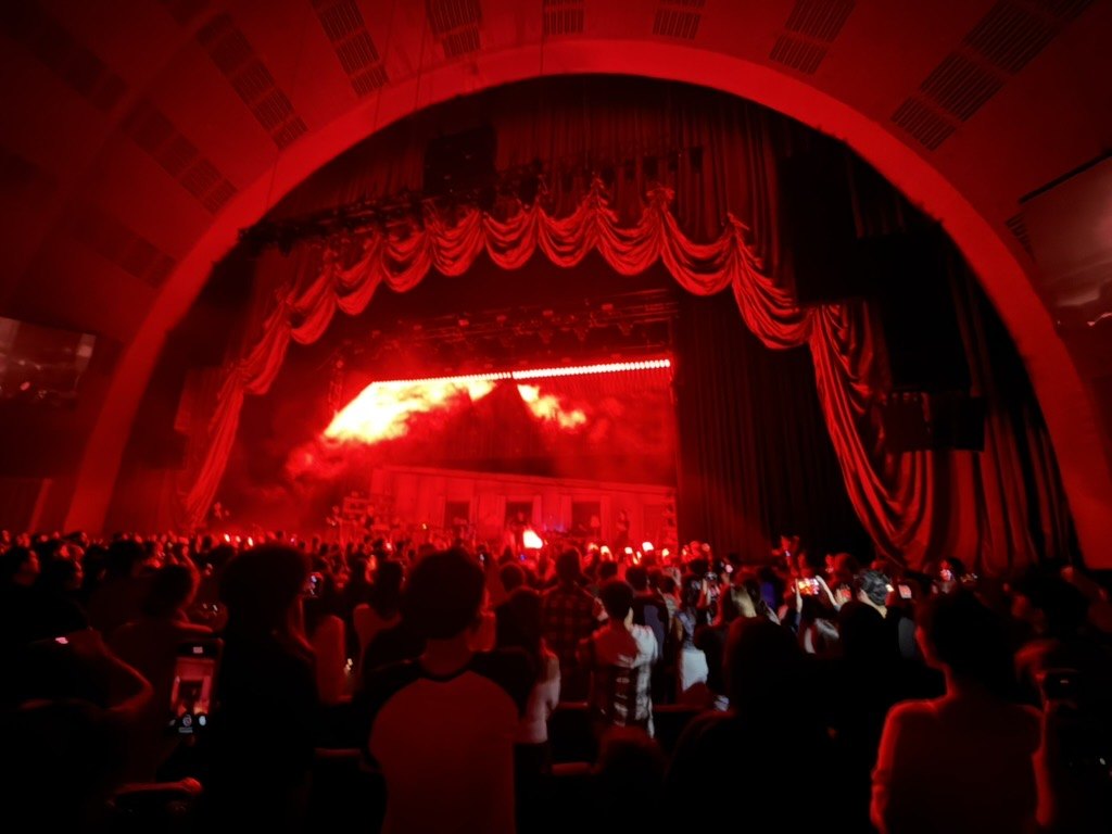 The proscenium arch at Radio City lit red during wave to earth's set